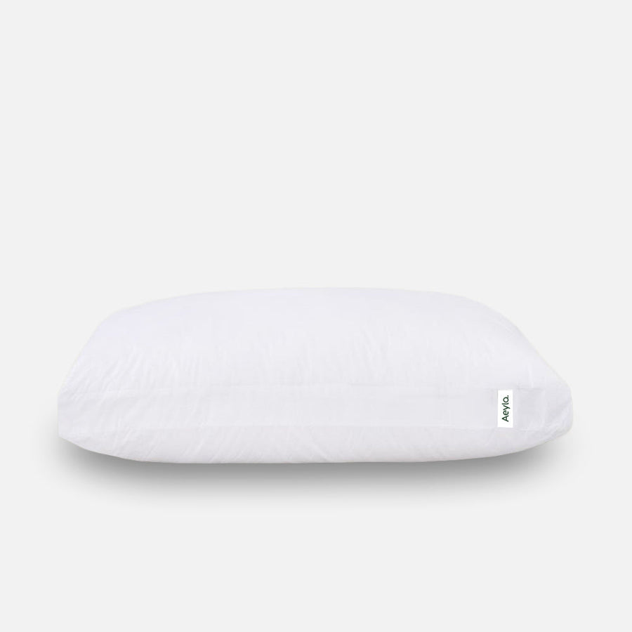 A regular pillow letting the neck drop, next to the Marlo Dual Pillow holding the neck level